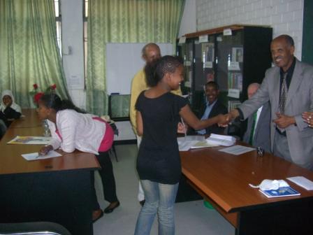 Professor Sisay Asefa awarding one of the awardees her bank book